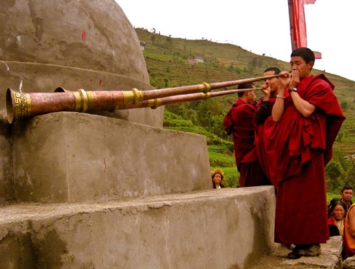 Nepal_Solu Khumbu Bumburi Buddhist Monks Blowing horns on stupa chorten.jpg