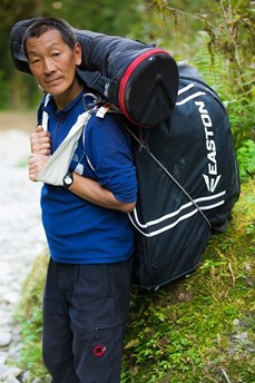 Local porter carrying a trekkers bag.jpg